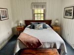 Spacious primary bedroom on the first floor with a queen bed